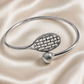 Wire Flex Racquet and Ball Bracelet close-up with silver racquet charm and tennis ball