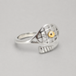 14K Gold Tennis Ball Ring angled to show the silver band and gold tennis ball