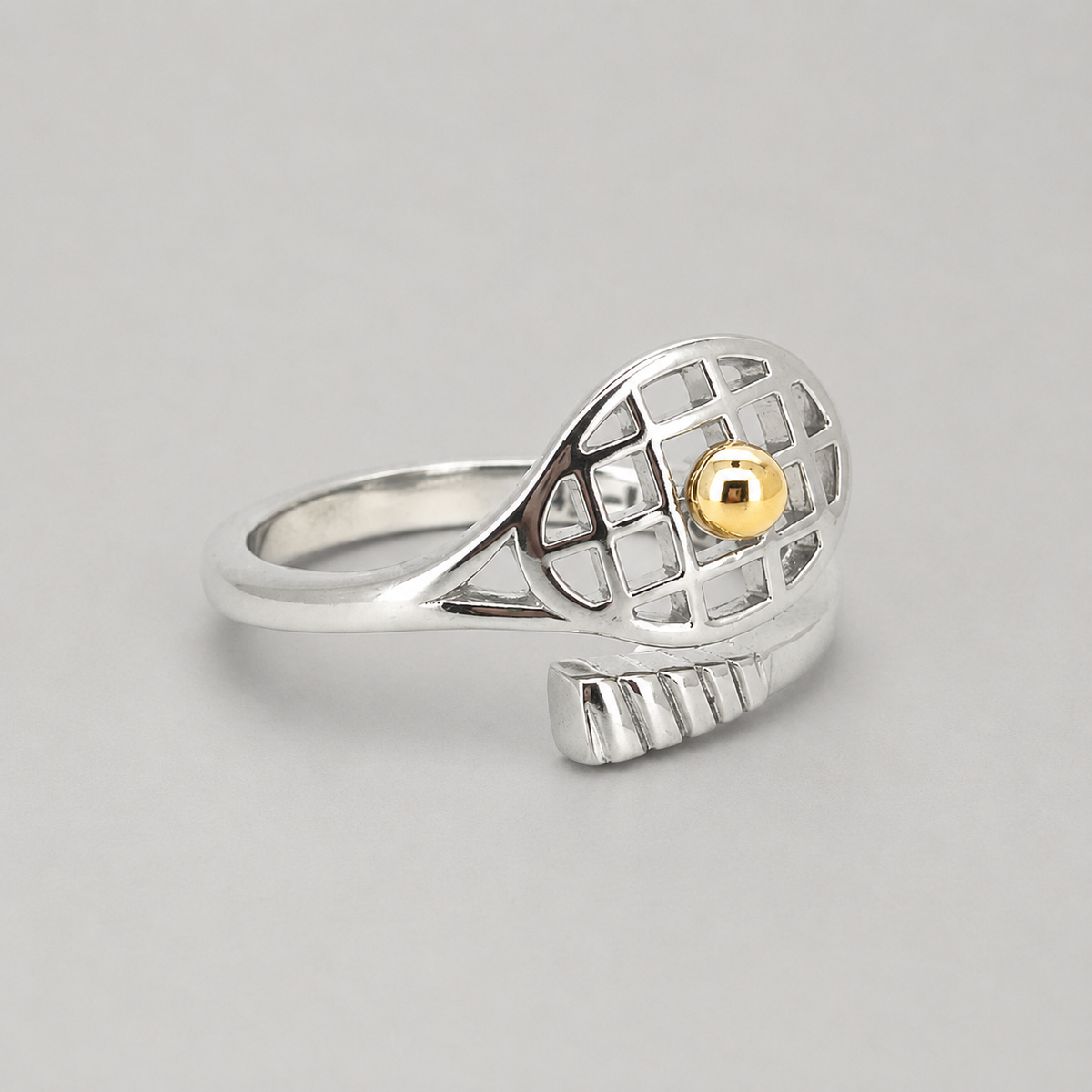 14K Gold Tennis Ball Ring angled to show the silver band and gold tennis ball