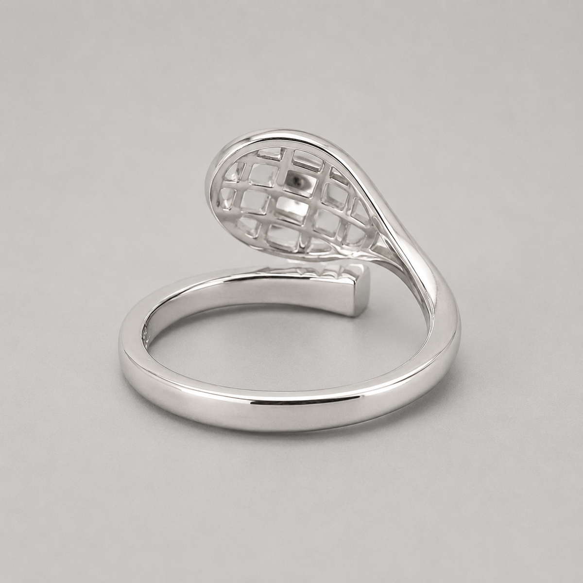 14K Gold Tennis Ball Ring with polished silver racquet design on grey