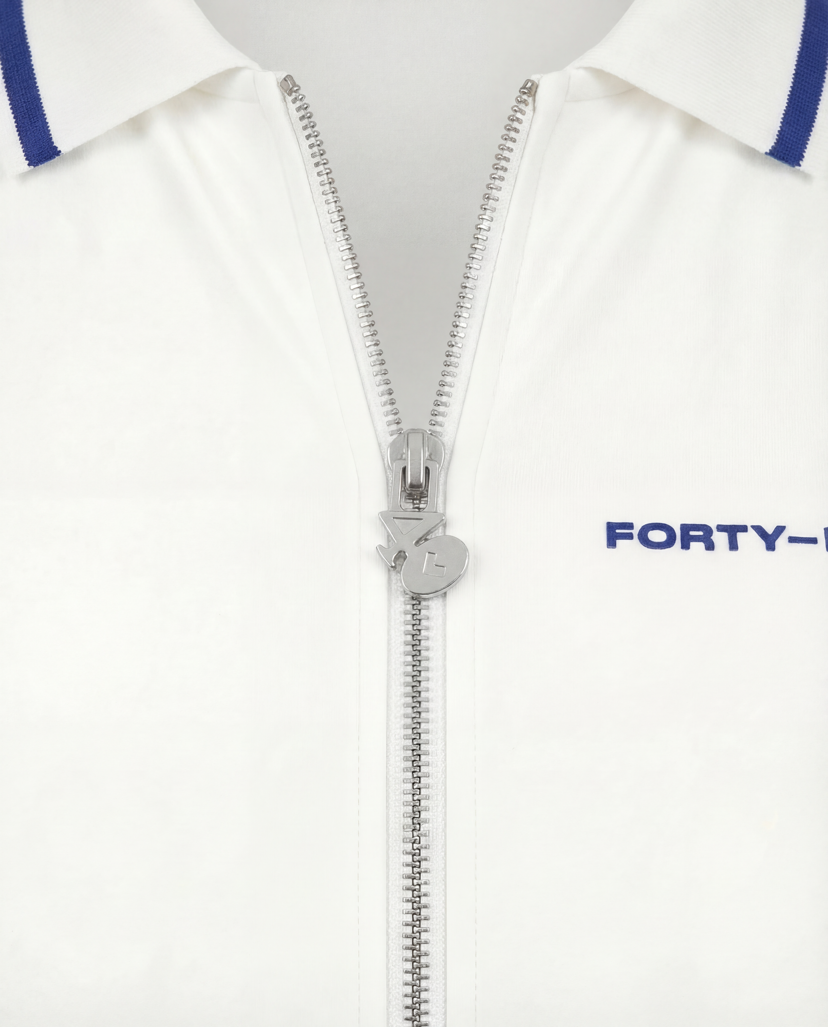 Close-up of zip neckline on a women’s tennis dress, featuring premium hardware and performance fabric.
