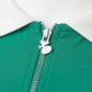 Close-up detail of zip fastening on a green women’s tennis tank top, highlighting quality hardware and design finish.