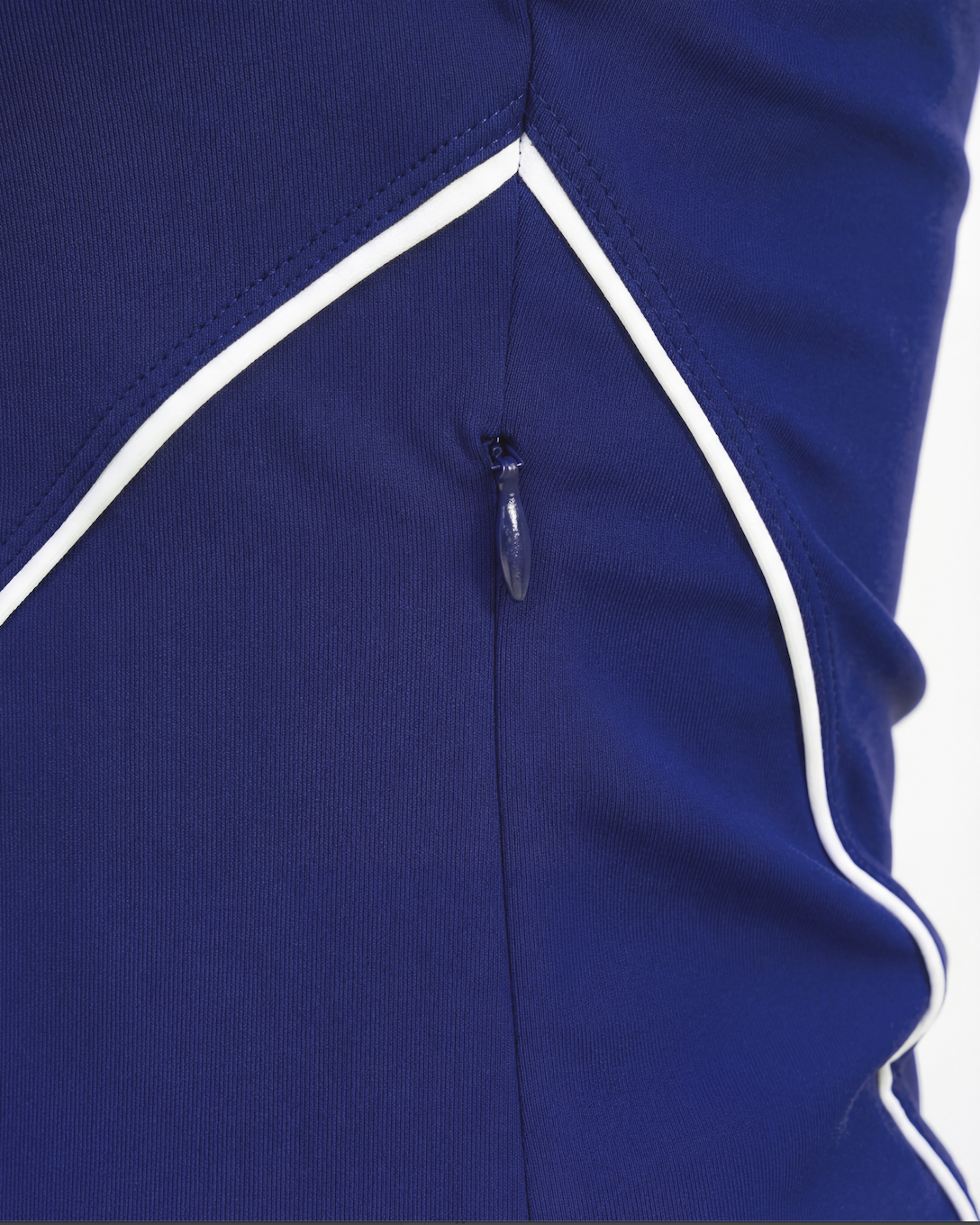Close-up detail of zip and seam on a women’s tennis jacket, showcasing premium construction and performance finish.