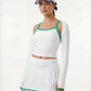 Studio image of a white tennis tank top with green detailing, worn as part of a coordinated women’s long sleeve tennis outfit.