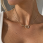 Sideways tennis necklace worn with a gold racquet pendant at the collarbone