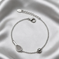Sleek tennis bracelet with silver racquet and ball detail on a white background