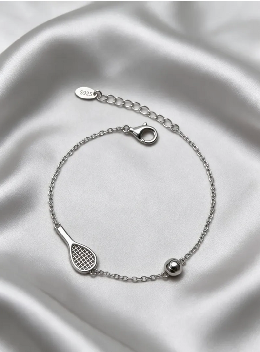 Sleek tennis bracelet with silver racquet and ball detail on a white background
