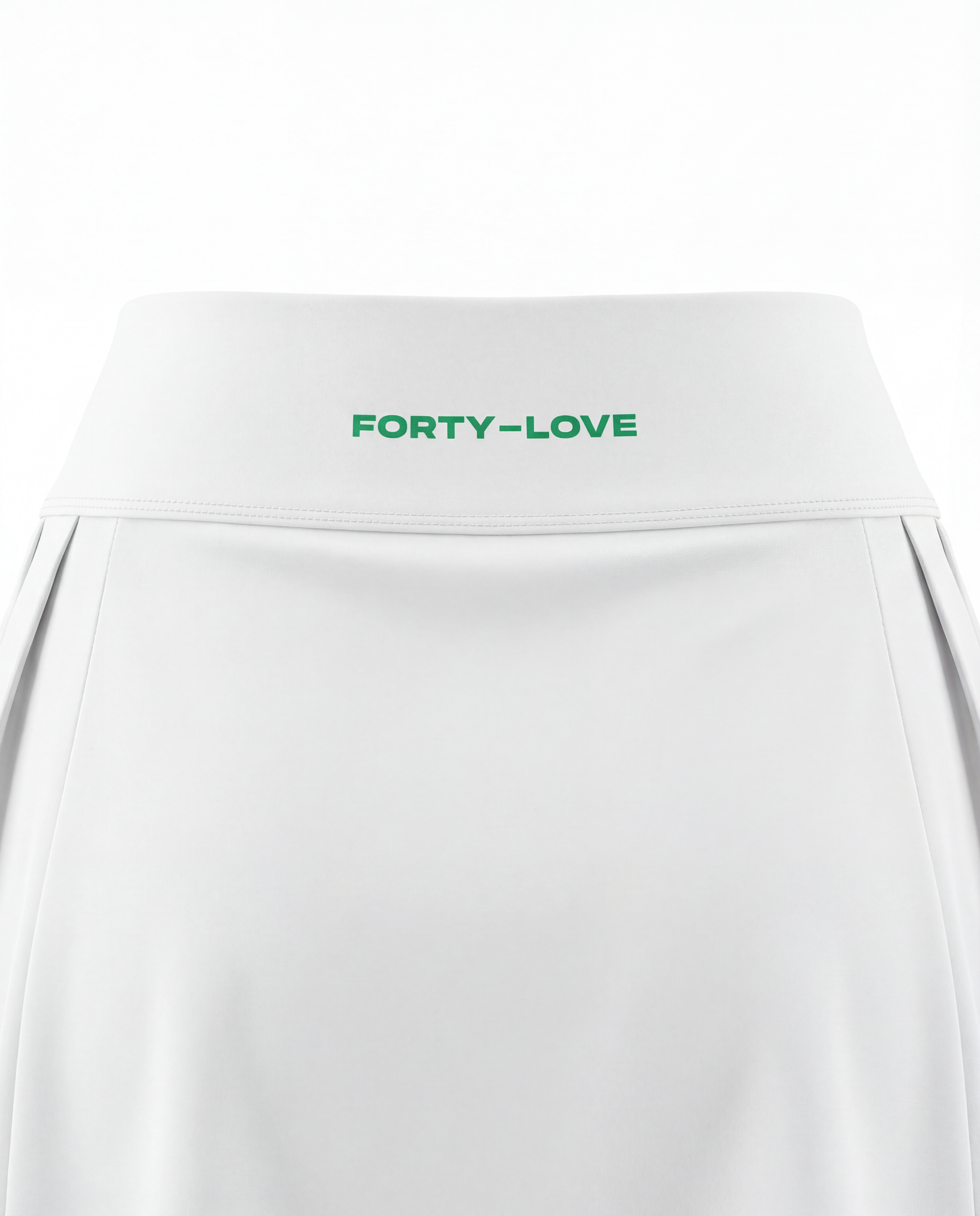 Close-up of waistband branding on a white women’s tennis skort, featuring Forty-Love logo detail.